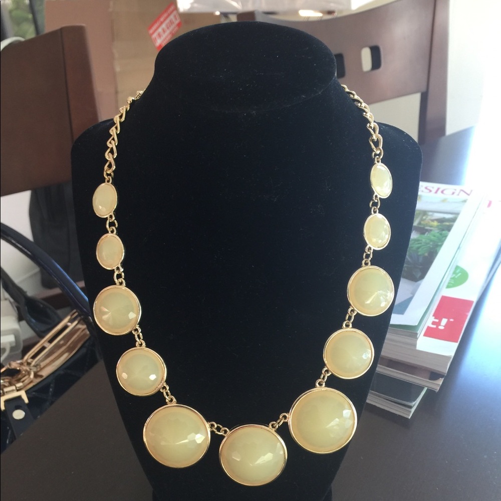 Gold tone necklace with beige beads